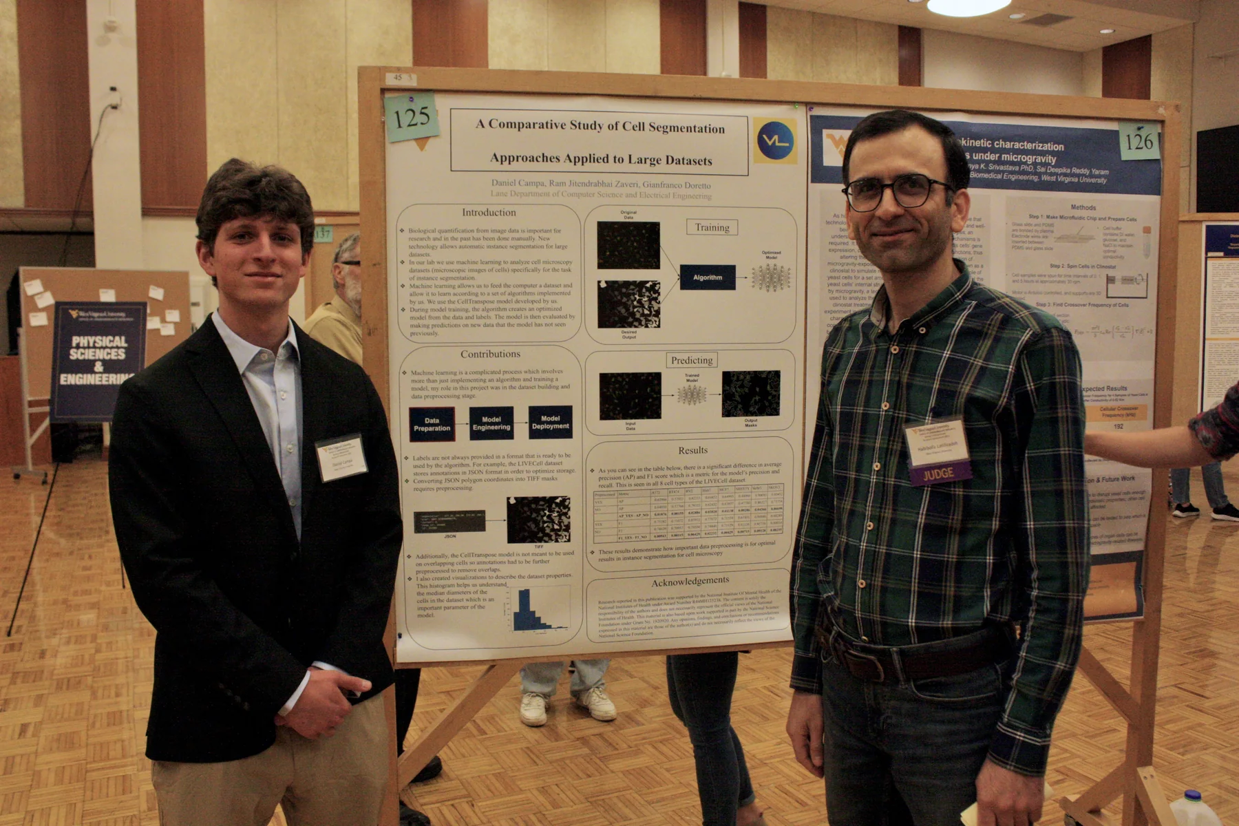 Habib Latifizadeh reviewing a student research poster